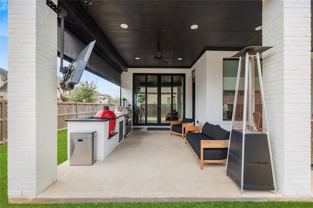 view of patio with ceiling fan, french doors, and fence