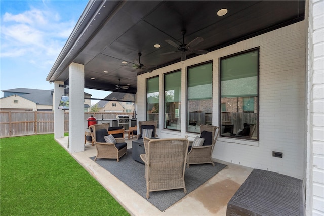 view of patio featuring fence, an outdoor hangout area, and a ceiling fan