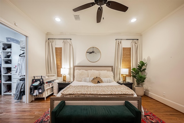 bedroom featuring recessed lighting, visible vents, wood finished floors, and ornamental molding