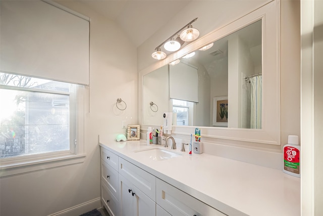 full bath with vanity and vaulted ceiling