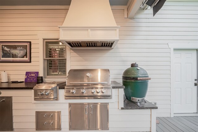 exterior space with an outdoor kitchen and a grill