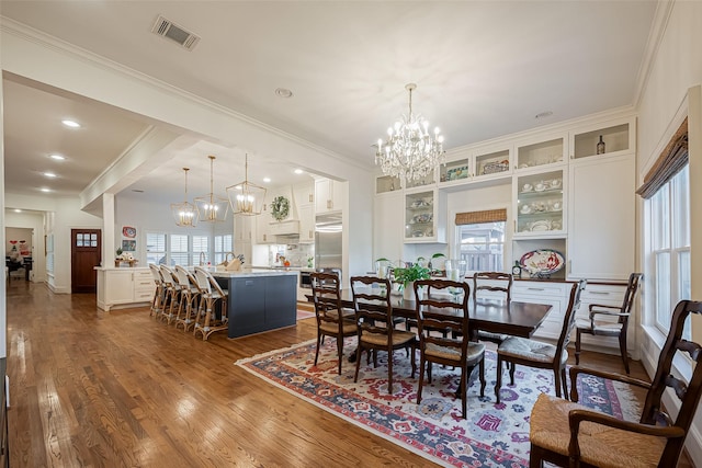 dining room featuring visible vents, recessed lighting, crown molding, a chandelier, and dark wood-style flooring