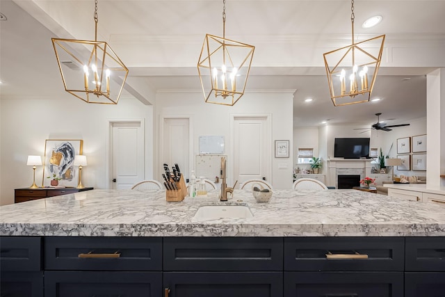 kitchen with a sink, crown molding, and light countertops