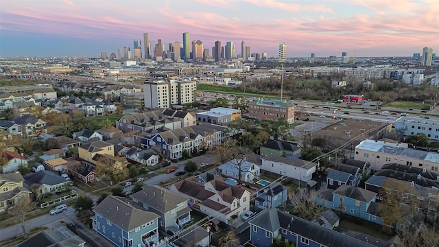 aerial view at dusk featuring a view of city