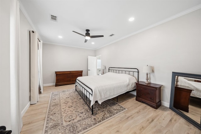 bedroom with baseboards, visible vents, wood finished floors, crown molding, and recessed lighting