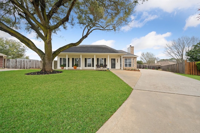 view of front of home featuring a front lawn, a chimney, and fence