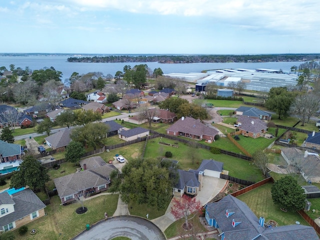 drone / aerial view featuring a water view and a residential view