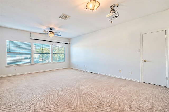 unfurnished room with baseboards, visible vents, a ceiling fan, and light colored carpet