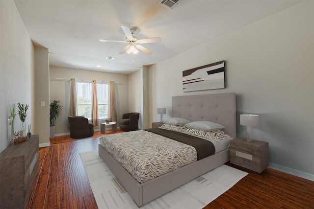 bedroom with baseboards, visible vents, ceiling fan, and wood finished floors