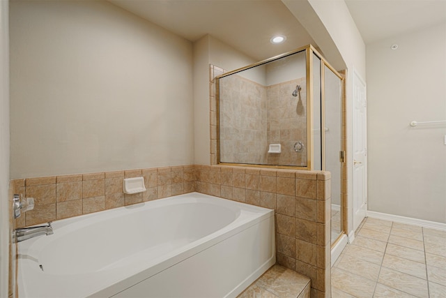 bathroom with baseboards, tile patterned floors, a garden tub, a shower stall, and recessed lighting