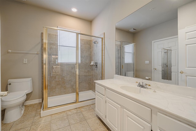 bathroom with a stall shower, tile patterned flooring, vanity, and toilet