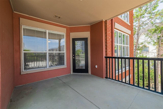 entrance to property with visible vents and stucco siding