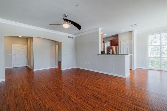 unfurnished living room with baseboards, visible vents, dark wood finished floors, and ornamental molding