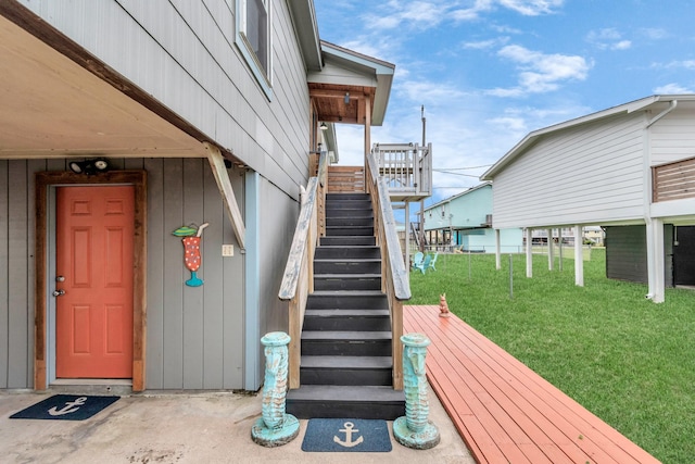 entrance to property with a deck and a yard