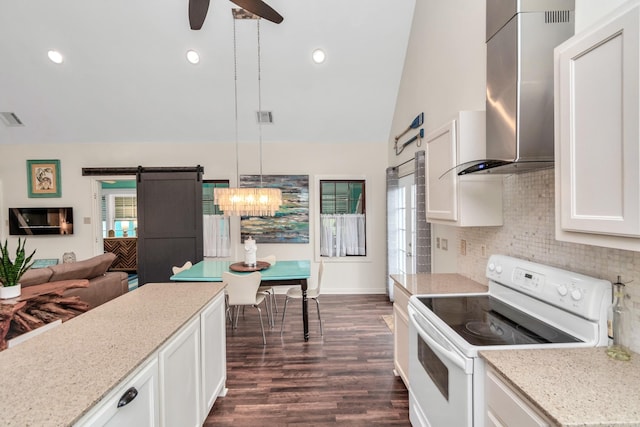 kitchen with white electric range oven, visible vents, a barn door, a ceiling fan, and wall chimney range hood