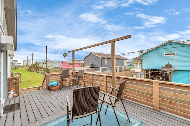 deck featuring a residential view and a lawn