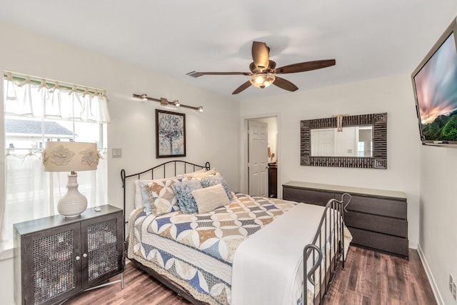 bedroom with ceiling fan, baseboards, and wood finished floors