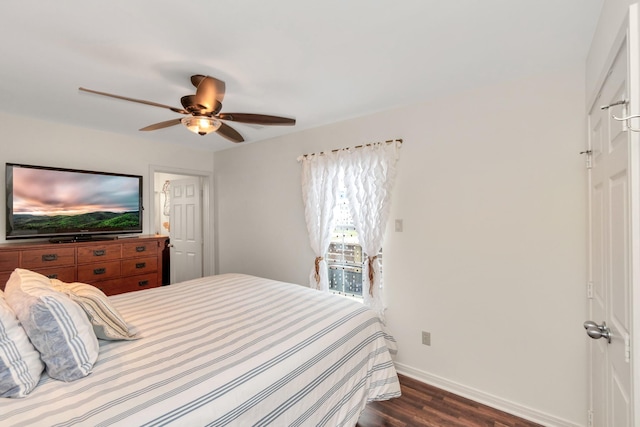 bedroom featuring dark wood-style floors, baseboards, and a ceiling fan