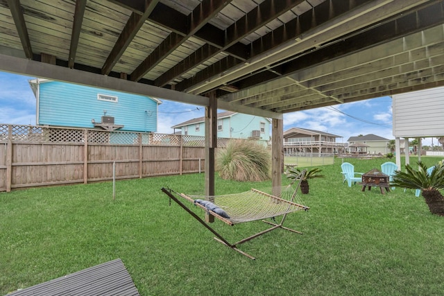 view of yard with an outdoor fire pit and fence