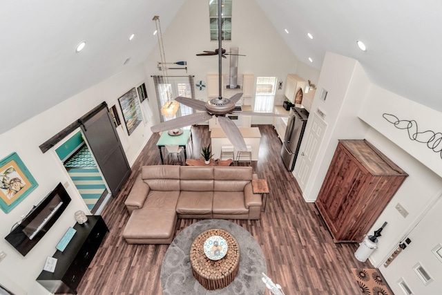 living area with high vaulted ceiling, a ceiling fan, recessed lighting, and wood finished floors