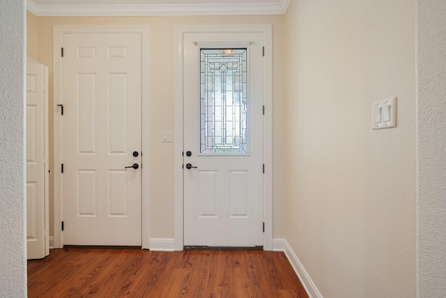 entryway with baseboards, ornamental molding, and wood finished floors