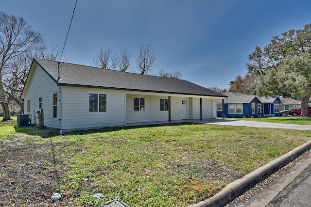 ranch-style home featuring a garage, concrete driveway, and a front lawn