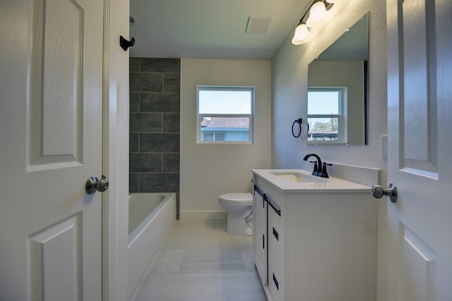 bathroom with visible vents, toilet, vanity, baseboards, and tile patterned floors