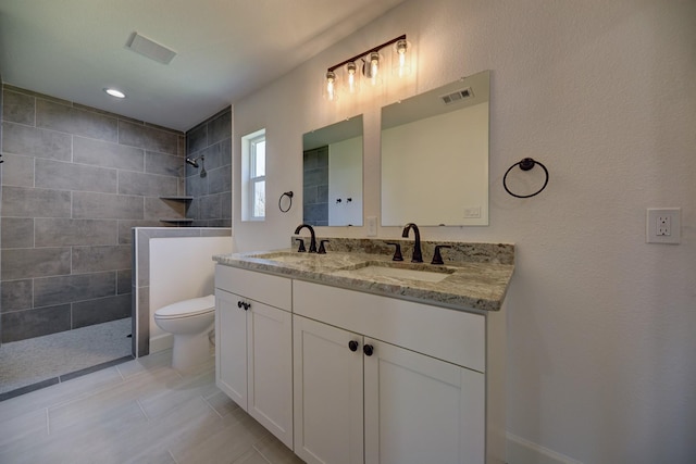 full bath featuring a walk in shower, a sink, and visible vents