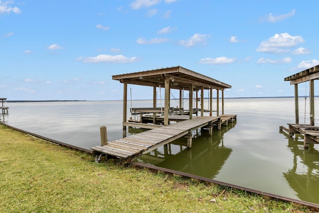 dock area with a water view and boat lift