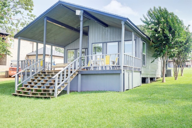 back of house featuring a deck, a yard, stairway, and central AC