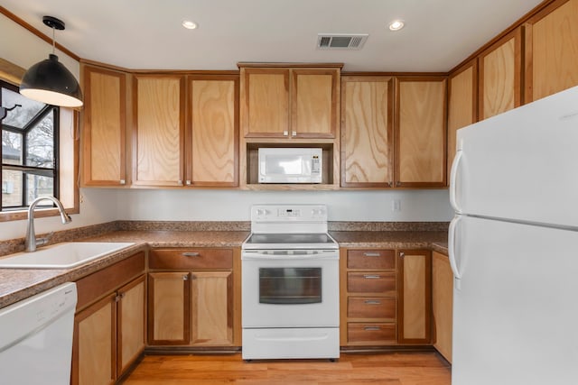 kitchen with recessed lighting, white appliances, a sink, visible vents, and light wood-style floors