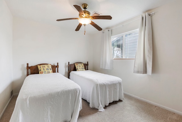 carpeted bedroom with a ceiling fan and baseboards