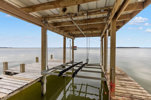 dock area with a water view and boat lift