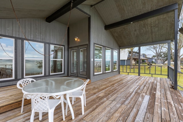 wooden terrace featuring a lawn