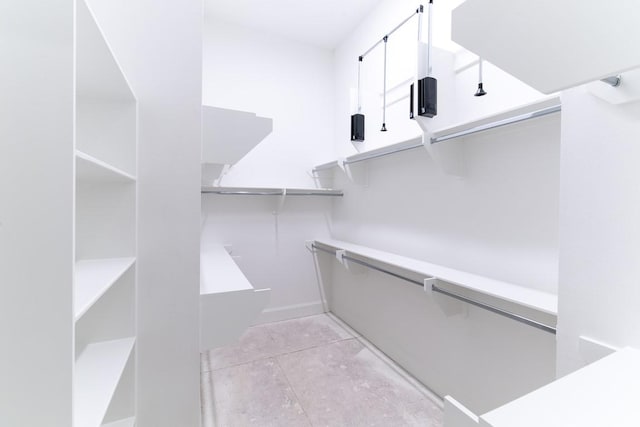 spacious closet featuring light tile patterned floors