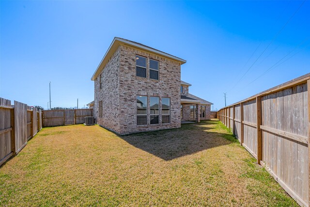 4046 Colony Ln, Missouri City, TX 77459 - back of house with a fenced backyard, a lawn, and brick siding