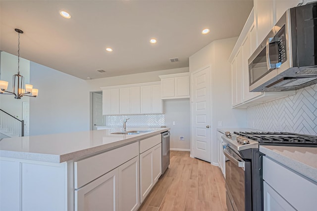4046 Colony Ln, Missouri City, TX 77459 - kitchen with white cabinetry, appliances with stainless steel finishes, a sink, and tasteful backsplash