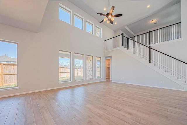4046 Colony Ln, Missouri City, TX 77459 - unfurnished living room with stairway, plenty of natural light, and a ceiling fan