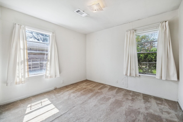 unfurnished room featuring visible vents and carpet flooring