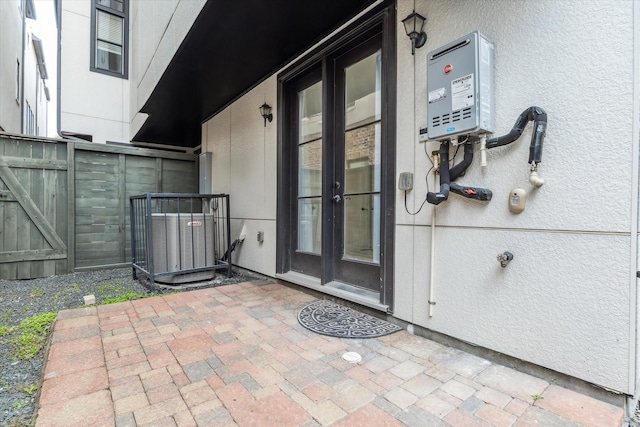 entrance to property featuring central AC unit and stucco siding