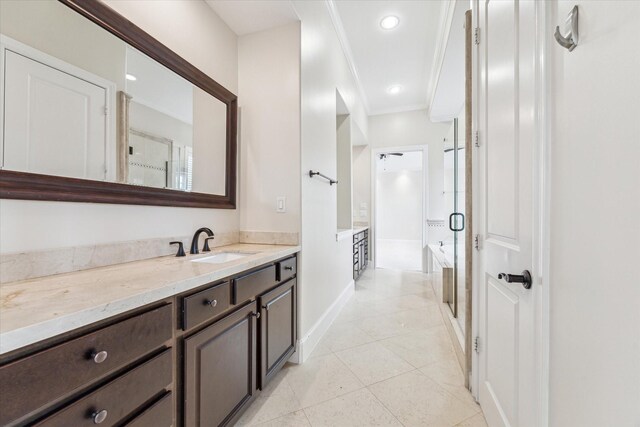 full bathroom featuring baseboards, a stall shower, vanity, and tile patterned floors