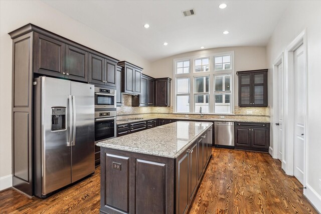 kitchen featuring dark brown cabinetry, visible vents, appliances with stainless steel finishes, and dark wood-style flooring