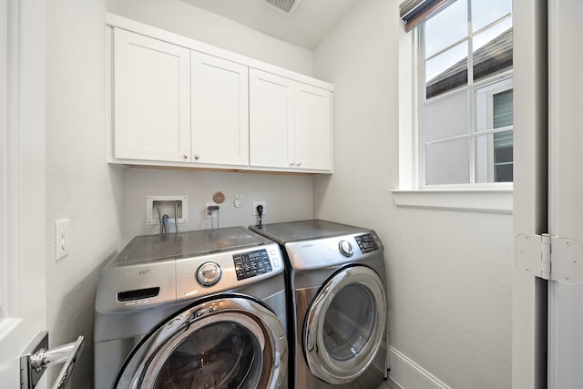 washroom with cabinet space and washer and dryer