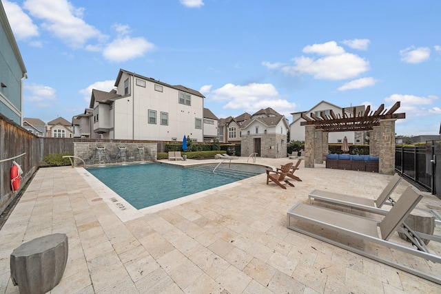 community pool featuring a residential view, a patio, fence, and a pergola