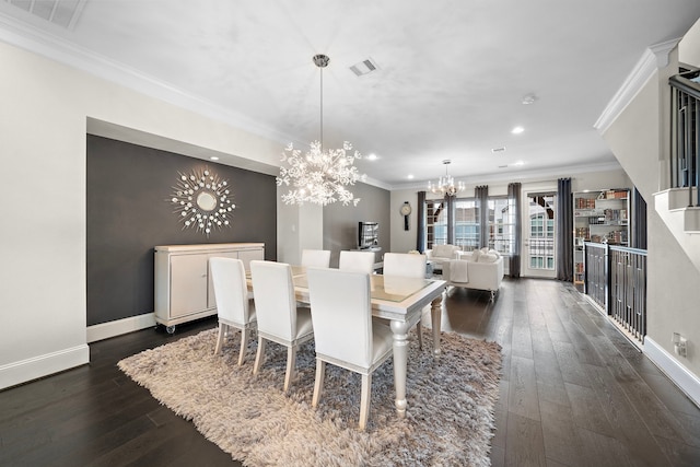 dining room featuring visible vents, a chandelier, dark wood finished floors, and ornamental molding