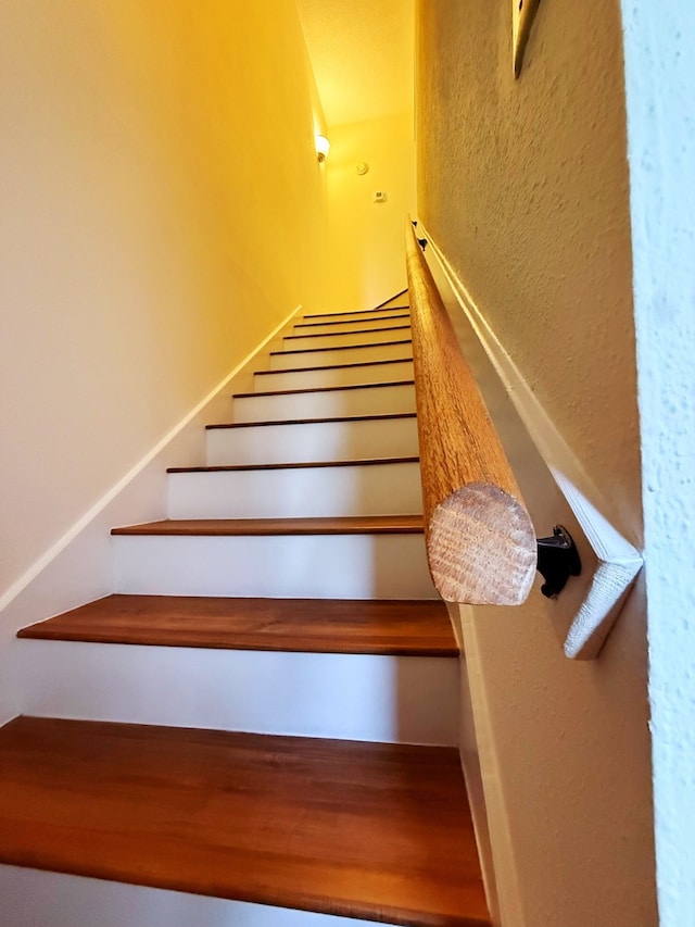 staircase with a textured wall