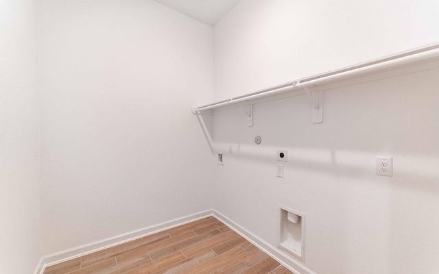 laundry room featuring gas dryer hookup, hookup for an electric dryer, laundry area, baseboards, and light wood-style floors