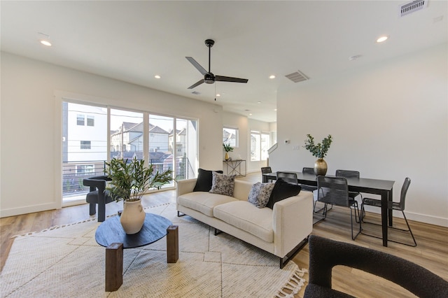 living area featuring light wood-style flooring, visible vents, and recessed lighting