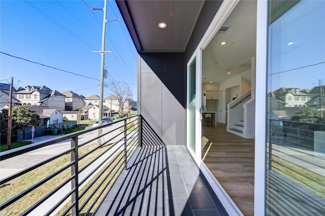 balcony featuring visible vents and a residential view