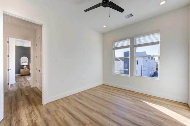 unfurnished room with recessed lighting, visible vents, light wood-style flooring, attic access, and baseboards